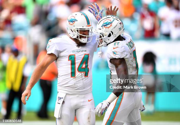 DeVante Parker of the Miami Dolphins celebrates with Ryan Fitzpatrick aftewr scoring a touchdown against the Washington Redskins in the fourth...