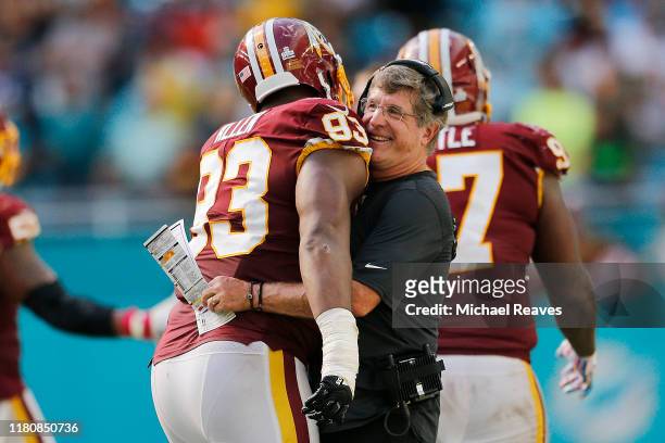 Interim head coach Bill Callahan of the Washington Redskins hugs Jonathan Allen after a stopping a two-point conversion attempt against the Miami...