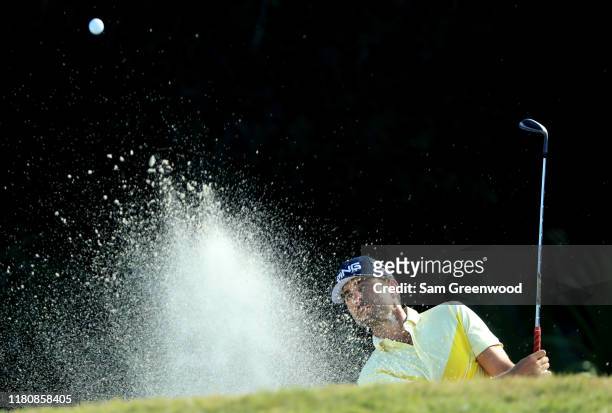 Scott Harrington of the United States plays a shot from a bunker on the 14th hole during the final round of the Houston Open at the Golf Club of...