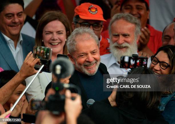 Former Brazilian President Luiz Inacio Lula da Silva smiles next to his girlfriend Rosangela da Silva after leaving the Federal Police Headquarters,...