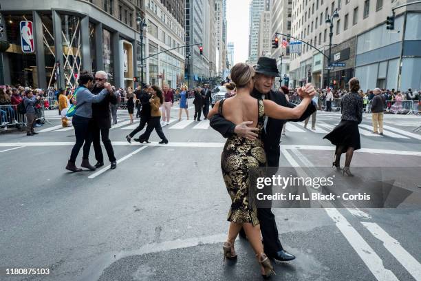 Couples dance together down 5th Avenue during the 55th Hispanic Day Parade. The parade walked down 5th Avenue in the Manhattan borough of New York on...