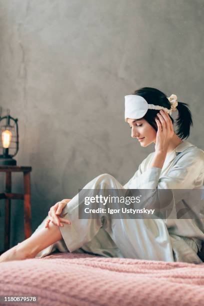 young cute woman with sleep mask - silk pajamas stock pictures, royalty-free photos & images
