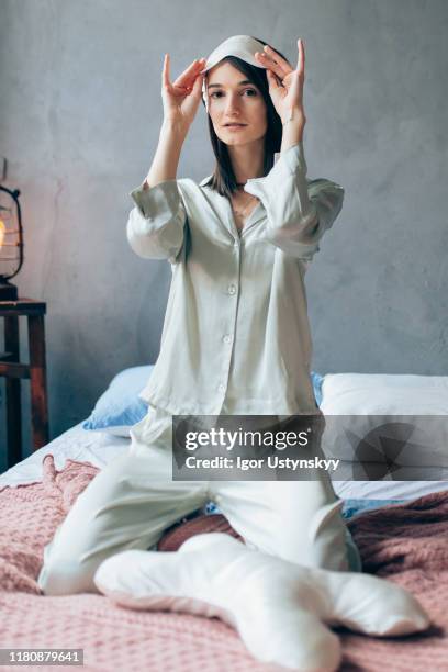young beautiful woman wearing a sleeping mask - nightwear stock pictures, royalty-free photos & images