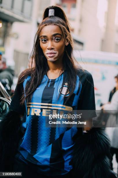 Model Winnie Harlow wears her hair in a high ponytail and wears a blue Pirelli soccer/football jersey after the Byblos show on Day 1 Milan Fashion...