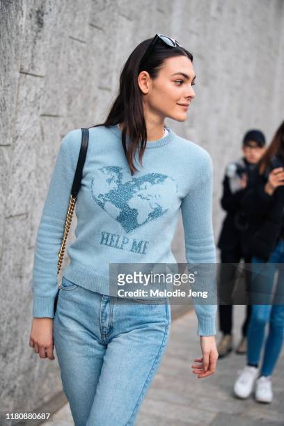 Model Vittoria Ceretti wears a blue Alberta Ferretti "help me" earth environmentalist sweater and blue jeans after the Alberta Ferretti show on Day 1...