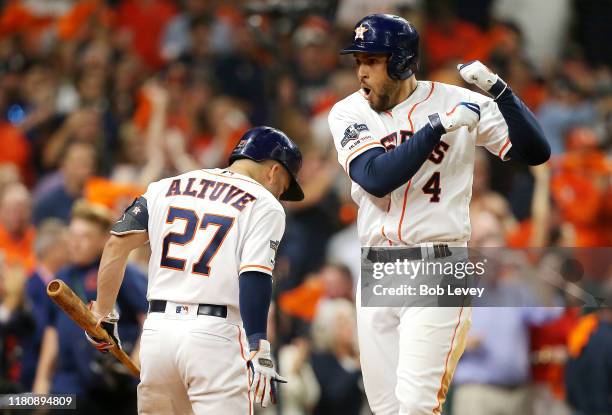 George Springer of the Houston Astros celebrates with Jose Altuve after hitting a solo home run during the fifth inning against the New York Yankees...