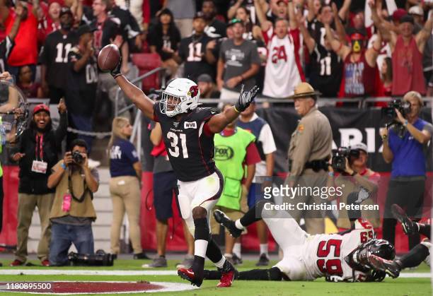 Running back David Johnson of the Arizona Cardinals celebrates after catching a 14 yard touchdown against outside linebacker De'Vondre Campbell of...