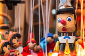 Pinocchio dolls with long nose. Conceptual fairy tale character.