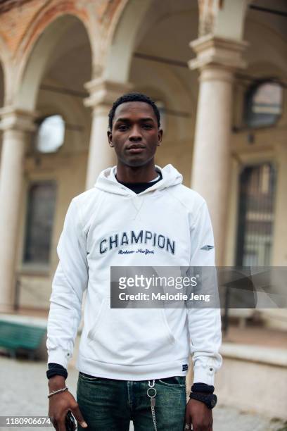 Model Daniel Morel wears a white Champion hoodie after the Salvatore Ferragamo show on Day 4 Milan Fashion Week Autumn/Winter 2019/20 on February 23,...