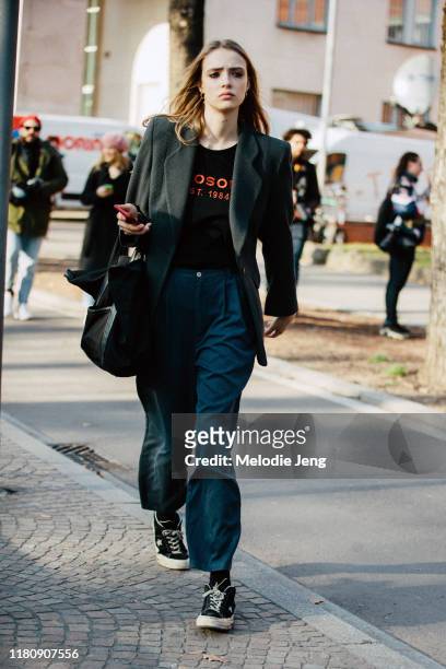 Model Charlotte Rose Hansen wears a chunky blazer, Philosophy t-shirt, blue trousers, and black Converse sneakers after the Philosophy di Lorenzo...