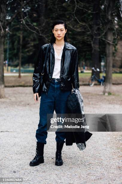 Model Chu Wong wears a black leather jacket, white shirt, blue corduroy pants after the Roberto Cavalli show on Day 4 Milan Fashion Week...