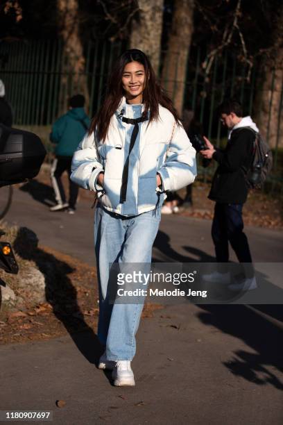 Model Hoyeon Jung wears a blue and white jacket, blue jeans, and white sneakers after the Philosophy di Lorenzo Serafini show on Day 4 Milan Fashion...