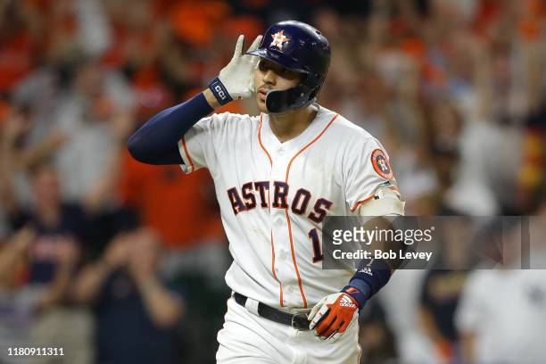 Carlos Correa of the Houston Astros celebrates hitting a walk-off solo home run during the eleventh inning against the New York Yankees to win game...