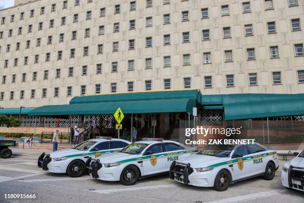 Police cars are seen outside the Miami-Dade County courthouse in Miami, Florida on November 8, 2019. - Eighteen former felons were granted the right...