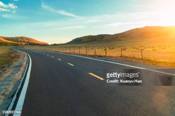 country road at sunset - country road stock pictures, royalty-free photos & images