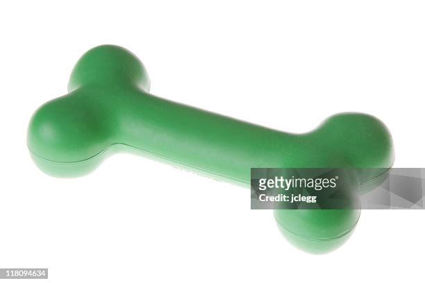 hueso para perro de goma verde - dog's toy fotografías e imágenes de stock
