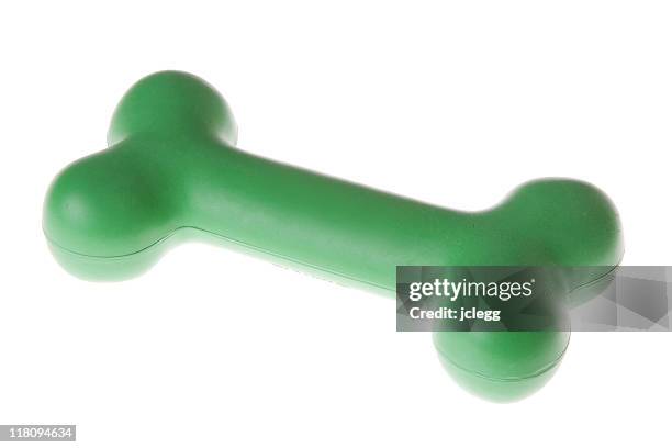 green rubber dog bone - dog's toy stockfoto's en -beelden