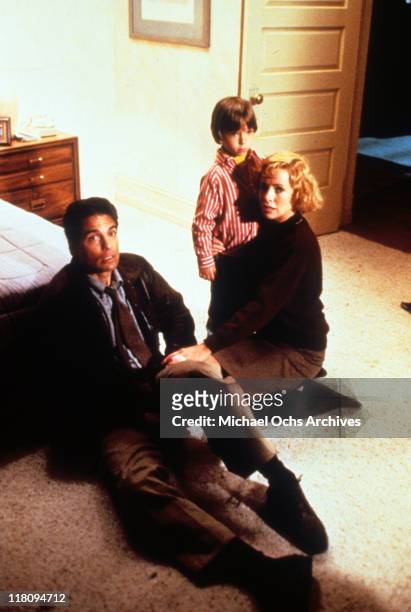 Actors Chris Sarandon and Catherine Hicks with child actor Alex Vincent in a scene from the film 'Child's Play', 1988.