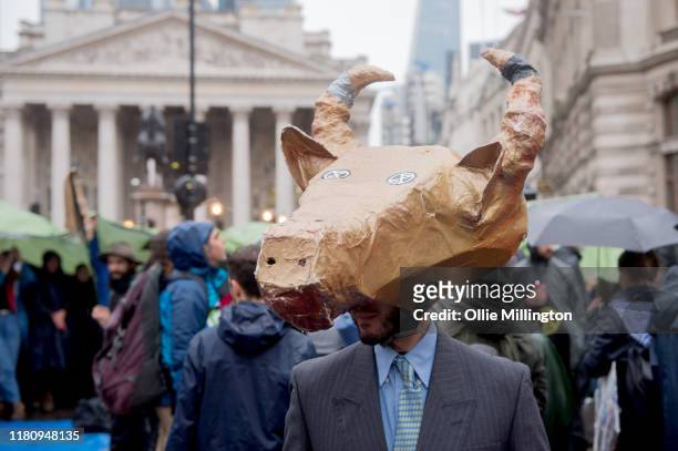 An Extinction Rebellion environmental activist wears a mask while protesting around Bank Junction in the financial district on the 7th day of their...