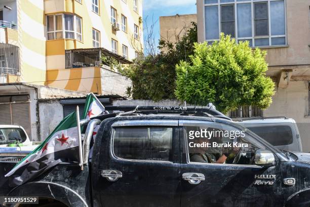 Members of Turkish-backed Free Syrian Army, a militant group active in parts of northwest Syria, head toward the Syrian town of Tal Abyad on October...