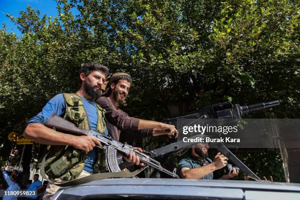 Members of Turkish-backed Free Syrian Army, a militant group active in parts of northwest Syria, heading toward Syrian town of Tal Abyad on October...