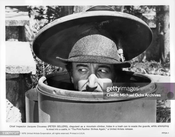 Peter Sellers as Inspector Clouseau is disguised as a mountain climber, while hiding in a trash can, in a scene from the film 'The Pink Panther...