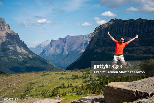 usa, montana, view of happy young man jumping in the air. - 1 august photos et images de collection