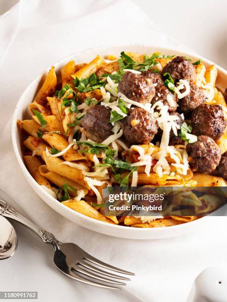 pasta and meatballs, penne pasta with meatballs in tomato sauce, penne pasta with meatballs - cheddar cheese stock pictures, royalty-free photos & images