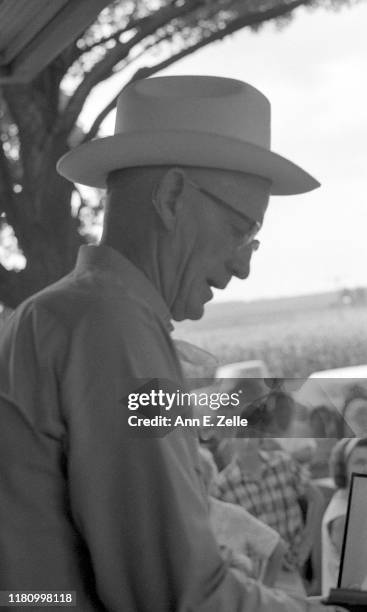 Close-up of American auctioneer Luke J Gaule as he conducts the sale of a farm, Illinois, June 1967.