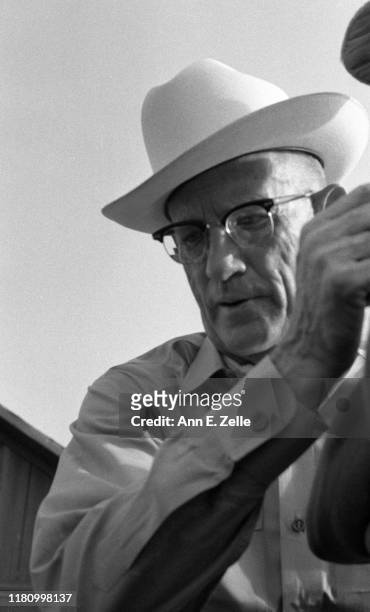 Close-up of American auctioneer Luke J Gaule as he conducts the sale of a farm, Illinois, June 1967.