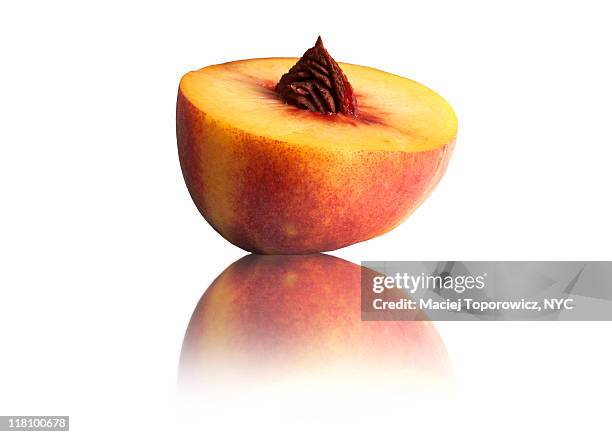 peach on reflective surface - half full stock pictures, royalty-free photos & images