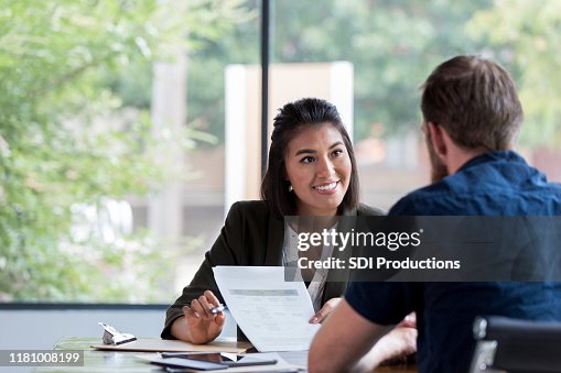 Cheerful businesswoman meets with client Cheerful businesswoman meets with client