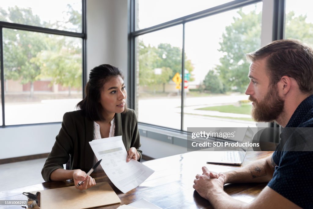 Loan officer reviews customer's loan application