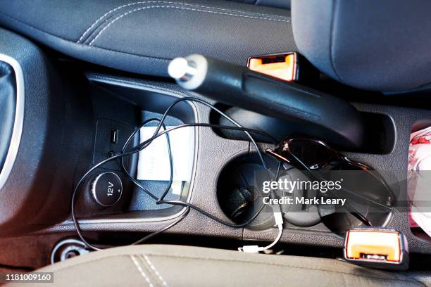 car interior with random cables and messy interior - messy car interior stock pictures, royalty-free photos & images