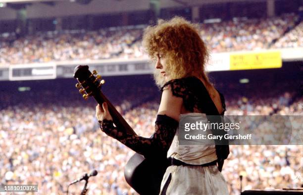 American Rock musician Nancy Wilson, of the group Heart, plays guitar as she performs onstage at Giants Stadium, East Rutherford, New Jersey, June...