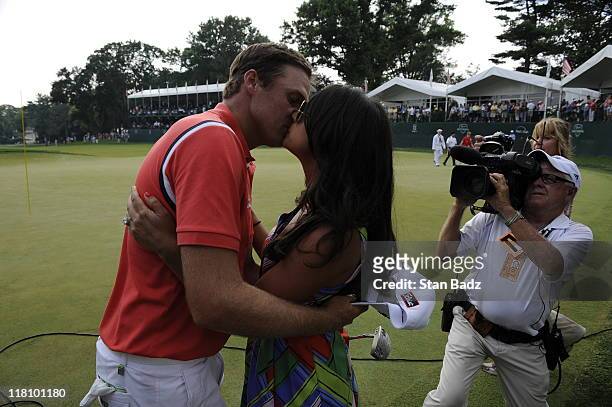Nick Watney receives a kiss from his wife Amber after winning the AT&T National at Aronimink Golf Club on July 3, 2011 in Newtown Square,...