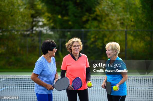 active seniors bonding at the tennis court - playful seniors stock pictures, royalty-free photos & images