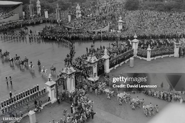 The Coronation of Queen Elizabeth II. The Queen and the Duke of Edinburgh return from Westminster Abbey, in the Gold State Coach, past cheering...