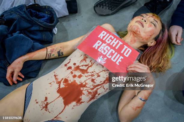 Protester covered in blood at the die-in in Whole Foods. Animal liberation activists with the grassroots animal rights network Direct Action...