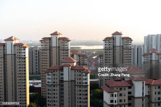 Large area of a high-rise residential district beside a wetland. According to the latest data, in October, the land transaction of 40 main Chinese...