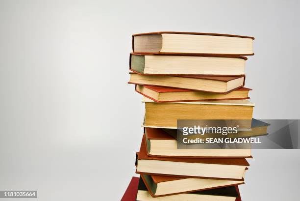pile of old books - history textbook stock pictures, royalty-free photos & images