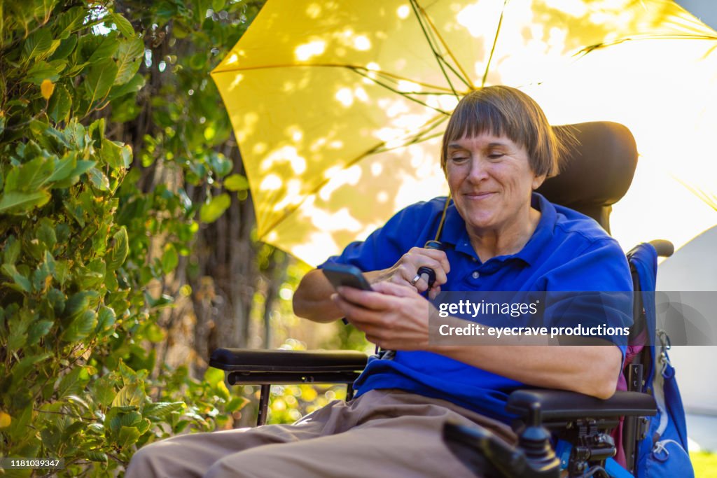 Senior Adult happy Female with physical disability of multiple sclerosis working around the home using various devices including technology to carry out everyday maintenance work and operations of the home in Western Colorado