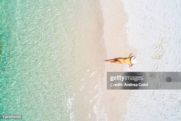 aerial view of a young woman enjoying a tropical beach - mauritius stock-fotos und bilder