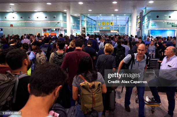 Passengers strand at the Barcelona Airport as thousands of protestors block the access in a protest following the sentencing of nine Catalan...