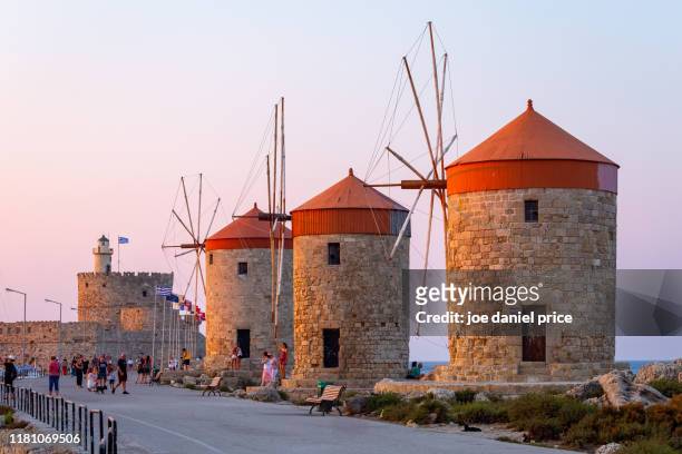 sunset, windmills rhodes old town, harbour, rodos, rhodes, greece - rhodes,_new_south_wales stock pictures, royalty-free photos & images