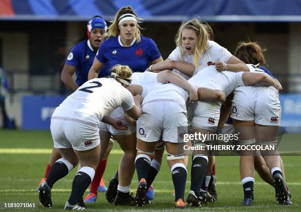 England's players carry the ball during a maul as part of the international women's Rugby union test match between France and England at the Marcel...