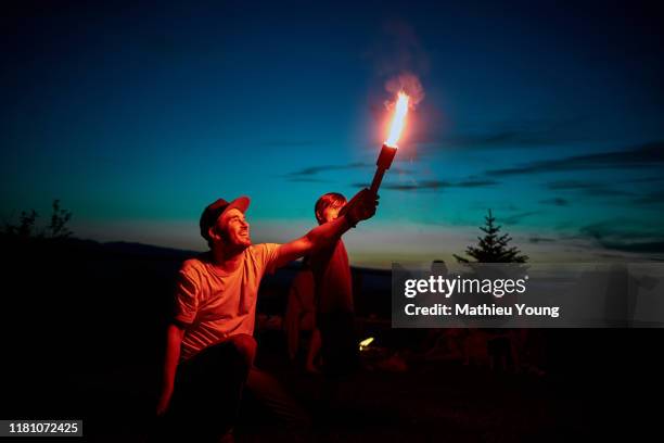 man and child with firework - fireworks dusk stock pictures, royalty-free photos & images