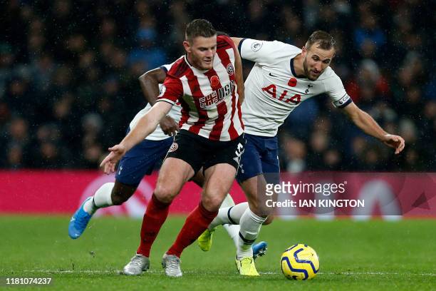 Sheffield United's English defender Jack O'Connell vies with Tottenham Hotspur's English striker Harry Kane during the English Premier League...