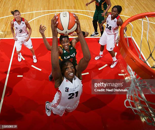 Nicky Anosike of the Washington Mystics rebounds against Swin Cash of the Seattle Storm at the Verizon Center on July 3, 2011 in Washington, DC. NOTE...