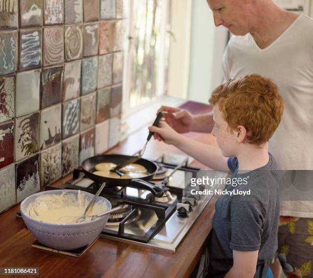 he like to help his father in cooking - nicky turner stock pictures, royalty-free photos & images